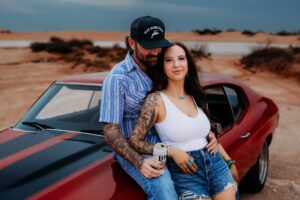 Western-style couples session featuring a 70s Chevelle and golden hour light in Carlsbad, NM.