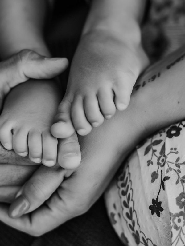 Parents holding the feet of their toddler
