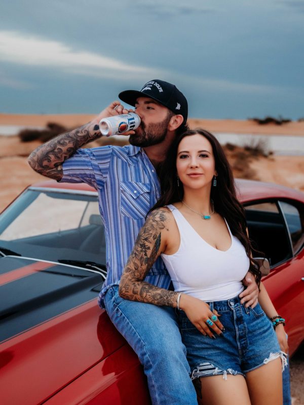 Western-style couples session featuring a 70s Chevelle and golden hour light in Carlsbad, NM.