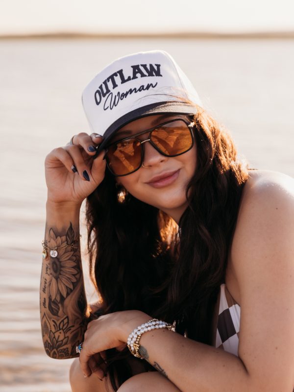 Retro 70s-inspired branding photo for Outlaw Tanning, showcasing bold western style at golden hour.
