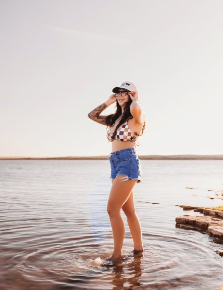 Retro 70s-inspired branding photo for Outlaw Tanning, showcasing bold western style at golden hour.